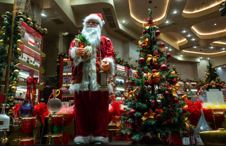 November 22, 2021, Moscow, Russia. Santa Claus and a Christmas tree in the window of a souvenir shop.のeditorial素材
