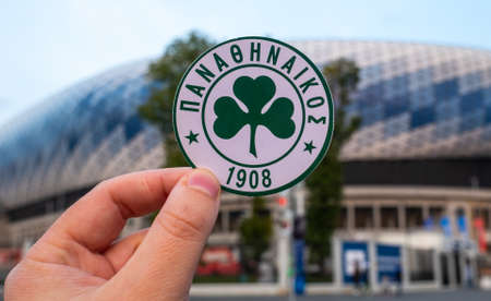 September 12, 2021 Athens, Greece. The emblem of the football club Panathinaikos FC and the UEFA Champions League Cup on the background of a modern stadium.のeditorial素材