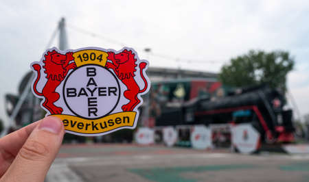 August 30, 2021, Leverkusen, Germany. The emblem of the Bayer 04 Leverkusen football club against the background of a modern stadium.のeditorial素材