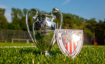 August 30, 2021, Bilbao, Spain. The emblem of the Athletic Bilbao football club and the UEFA Champions League Cup on the green turf of the stadium.のeditorial素材