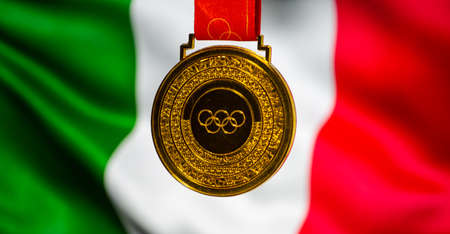 January 5, 2021, Beijing China. Gold medal of the XXIV Olympic Winter Games against the background of the flag of Italy.のeditorial素材