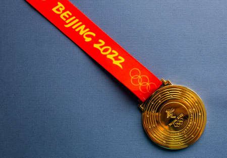 January 6, 2021, Beijing China. Gold medal of the XXIV Olympic Winter Games on a blue background.のeditorial素材