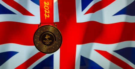 January 5, 2021, Beijing China. Gold medal of the XXIV Olympic Winter Games against the background of the flag of Great Britain.のeditorial素材