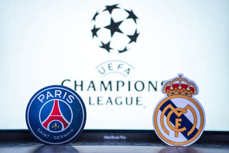January 2, 2022 St. Petersburg, Russia. The emblems of the football clubs of the 1/8 finals of the UEFA Champions League Paris Saint-Germain FC and Real Madrid CF against the background of the tournament emblem.のeditorial素材