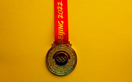 January 6, 2021, Beijing China. Gold medal of the XXIV Olympic Winter Games on a yellow background.のeditorial素材