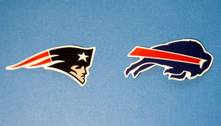 January 14, 2022. Orchard Park, New York. The emblems of the football clubs of the playoffs of the National Football League season 2021/2022 New England Patriots and Buffalo Bills on a blue background.のeditorial素材