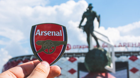 June 14, 2021 London, UK. Arsenal FC football club emblem against the backdrop of a modern stadium.のeditorial素材