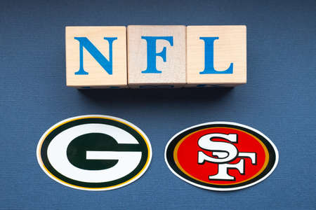 January 20, 2022. Green Bay, Wisconsin. The emblems of the football clubs of the playoffs of the National Football League San Francisco 49ers and Green Bay Packers on a blue background.のeditorial素材