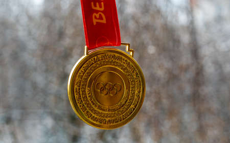 January 14, 2022, Beijing, China. Gold medal of the XXIV Olympic Winter Games against the background of snowy nature.のeditorial素材