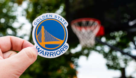 September 15, 2021, San Francisco, USA, A man holds the emblem of the basketball club Golden State...