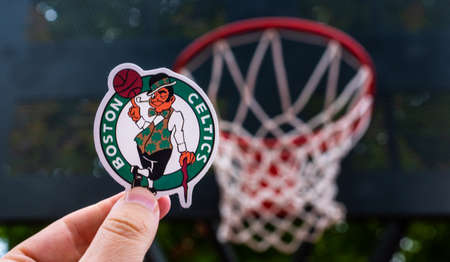 September 15, 2021, Boston, USA, A man holds the logo of the Boston Celtics basketball club in his...