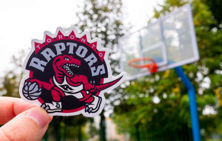 September 15, 2021, Toronto, Canada, A man holds the emblem of the Toronto Raptors basketball club...