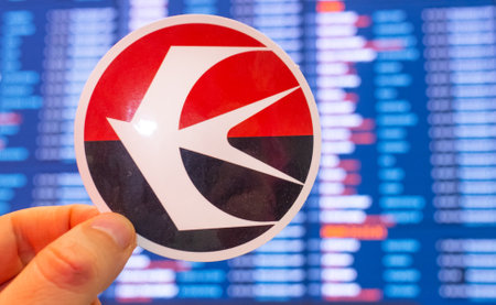 December 11, 2021, Shanghai, China. The emblem of China Eastern Airlines against the background of an electronic board with flight schedules at the international airport.のeditorial素材