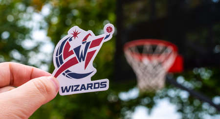September 15, 2021, Washington, USA, A man holds the emblem of the Washington Wizards basketball...