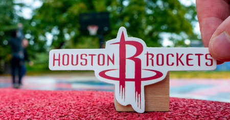 September 15, 2021, Houston, USA, A man holds the emblem of the Houston Rockets basketball club in...