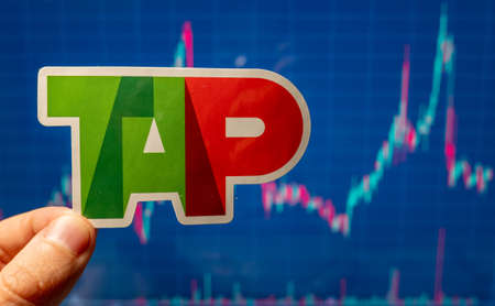 November 10, 2021 Lisbon, Portugal. TAP Portugal emblem against the background of a share price chart.のeditorial素材