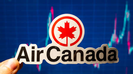 November 10, 2021 Montreal, Canada. The emblem of the Air Canada airline against the background of a stock price chart.のeditorial素材