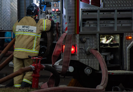 December 13, 2019, Moscow, Russia Emergencies Ministry employee at the fire engine during a fire.のeditorial素材