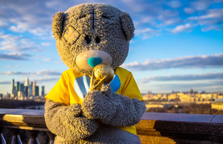 April 13, 2018, Moscow, Russia. An animator in a teddy bear costume holds the FIFA World Cup in his hands.のeditorial素材