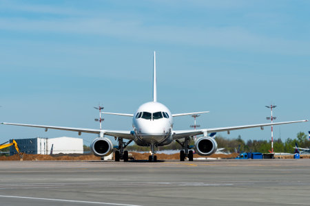White twin-engine passenger plane on the tarmac of the international airport