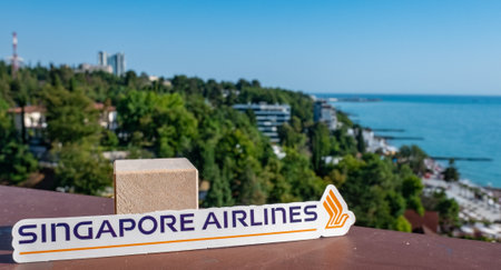 August 26, Sochi, Russia. The emblem of Singapore Airlines Singapore Airlines on the background of the embankment and the seashore in the resort town.のeditorial素材