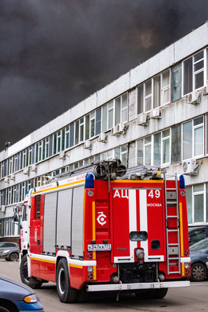 December 13, 2019, Moscow, Russia. A fire service vehicle at the scene of a fire in the industrial quarter.のeditorial素材