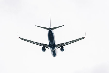 Passenger plane comes in for landing in cloudy weather.