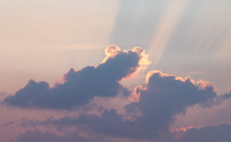 The rays of the setting sun break through the clouds. Sunsetの写真素材