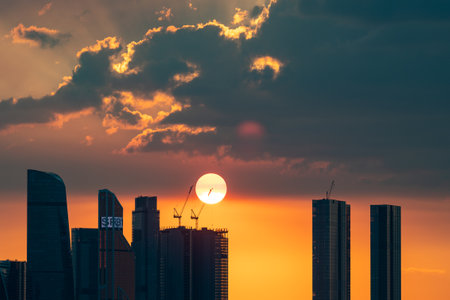 August 16, 2022, Moscow, Russia. The setting sun over the skyscrapers of the Moscow City office center on a summer evening. Sunset.のeditorial素材