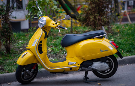 October 23, 2022. Moscow, Russia. A yellow Vespa scooter in the courtyard of a residential building...