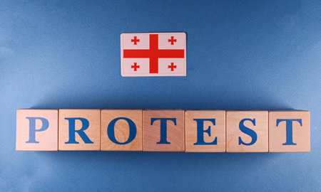 The description is made of wooden cubes. Protests are taking place in Georgia against the background of violations in the parliamentary elections.の写真素材
