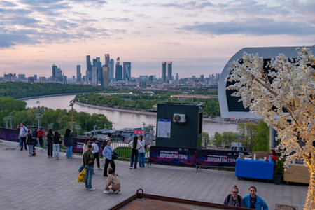 Passers-by at the observation deck on Vorobyovy Gory. In the background is the Moscow City business complex.の写真素材