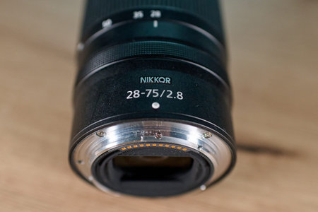 October 4, 2025, Moscow, Russia. The lens for the Nikon z 28-75mm f/2.8 mirrorless camera is on the table.のeditorial素材