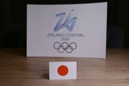 February 9, 2026. Milan, Italy. Japan flag on the background of the XXV Winter Olympic Games logo...