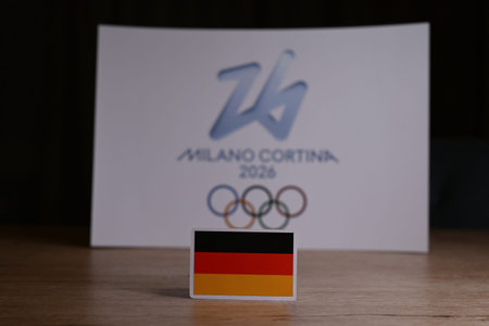 February 9, 2026. Milan, Italy. The flag of Germany on the background of the XXV Winter Olympic Games logo and commonly known as Milano Cortina 2026のeditorial素材