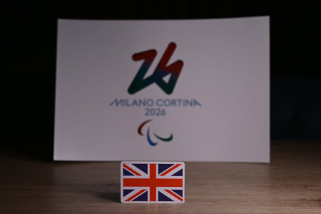 February 9, 2026. Milan, Italy. The flag of Great Britain on the background of the logo of the XIV...