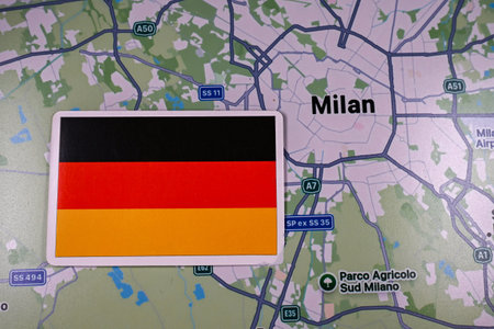 February 9, 2026, Milan, Italy. German flag on the background of a map of Milan, one of the host cities of the XXV Winter Olympic Games logo and commonly known as Milano Cortina 2026のeditorial素材