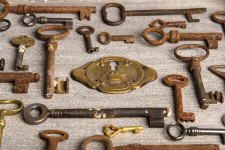 Brass lock surrounded by rusty antiques keysの写真素材