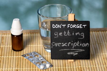 Prescription reminder on glass table with medicine
