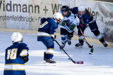 Fuerstenfeldbruck, Bavaria, Germany - 06. February 2016: German Kids playing ice hockey. Age is about 10 years. Players are fighting for the puck.のeditorial素材