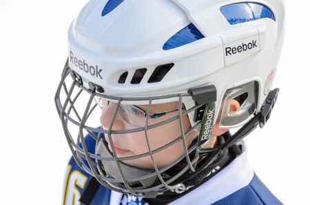 Fuerstenfeldbruck, Bavaria, Germany - 06. February 2016: German Kids playing ice hockey. Age is about 10 years. Head shot of one player.のeditorial素材