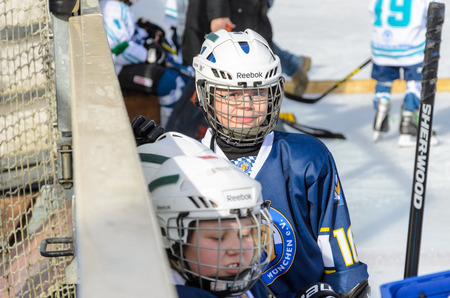Fuerstenfeldbruck, Bavaria, Germany - 06. February 2016: German Kids playing ice hockey. Age is about 10 years. Players resting on the bench.のeditorial素材