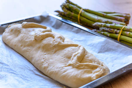 Preparation of a gourmet meal in pastry crust with green asparagusの写真素材