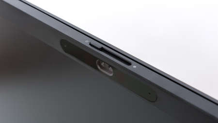 Close up on web cam with face recognition and privacy shutter of a modern video conference monitor