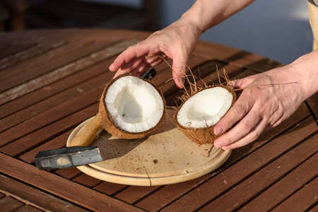 Close up on hands hammering a coconut.の写真素材