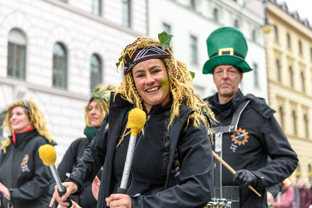 MUNICH, BAVARIA, GERMANY -  MARCH 13, 2016: Drummers at the St. Patrick's Day Parade. The name of the Afro-Brasil-Music-Band isâ VemComigoâ. Founder Andrea Thaller in front.のeditorial素材