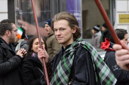 MUNICH, BAVARIA, GERMANY -  MARCH 13, 2016: close up on man holding a glag at the St. Patrick's Day Parade.のeditorial素材
