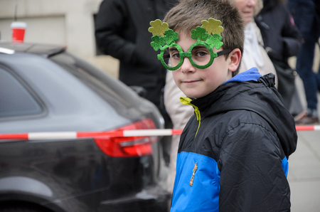 MUNICH, BAVARIA, GERMANY -  MARCH 13, 2016: close up on boy with green glasses looking like Harry Potter at the St. Patrick's Day Parade.のeditorial素材