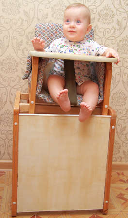adorable baby on highchair, at homeの写真素材