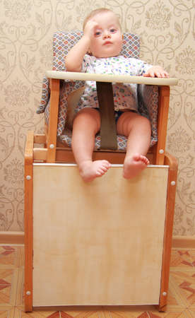 adorable baby on highchair, at homeの写真素材